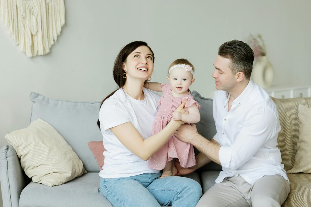 parents with their baby daughter in their family home